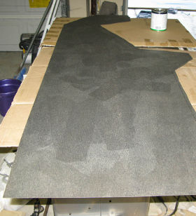 Applying contact cement to back of Formica